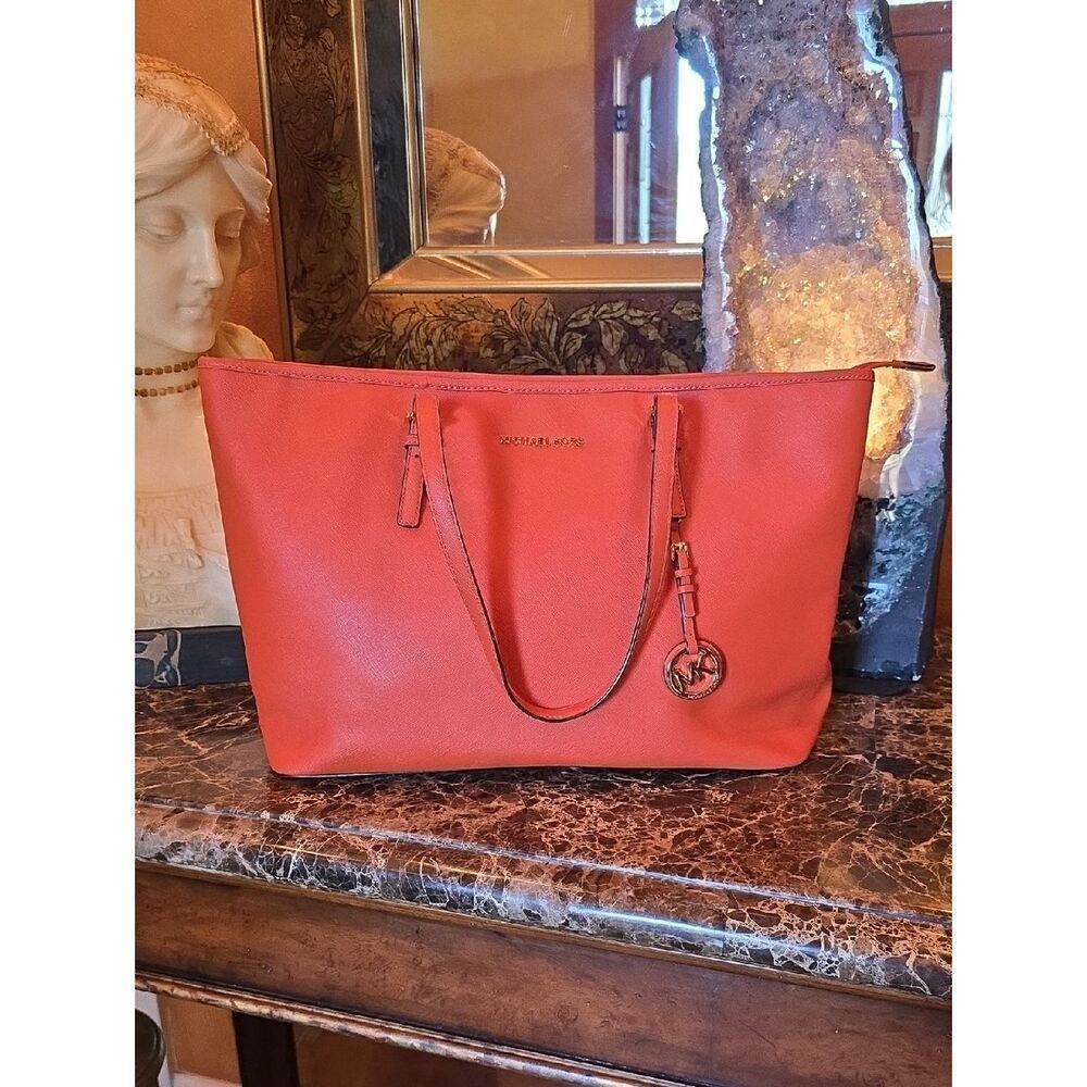 Michael KorsโCoral Red Leather Tote with Signature Charm